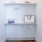 closet with hangers and bags on shelf